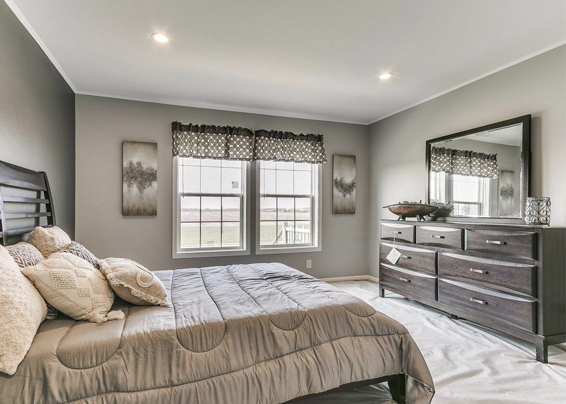 Modular home primary bedroom by Highland Manufacturing.